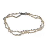 A two row necklace of cultured pearls, graduating in size to the front, on a rose diamond set clasp,