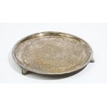 A silver salver of circular form, with engraved decoration within a reeded rim,