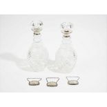 A pair of silver mounted faceted glass decanters and stoppers, London 1965,