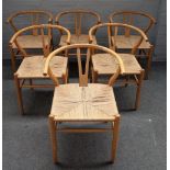 After Hans J Wegner, a set of six wishbone design beech framed dining chairs, 57cm wide x 77cm high.