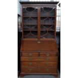 A George III mahogany bureau bookcase, the pair of glazed doors over fitted interior,