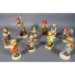 A group of ten Hummel figurines.