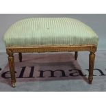 A Louis XVI style giltwood rectangular footstool, on fluted tapering supports,