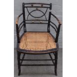 A Regency ebonised and parcel gilt faux bamboo open armchair, on splayed supports,