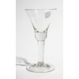 A plain stemmed wine glass circa 1740, the waisted bell bowl raised on a plain stem and plain foot,
