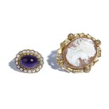 A 9ct gold brooch, mounted with an oval cabochon amethyst to the centre,