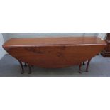 A mid-18th century style elm oval double gateleg action drop flap wake table on pad feet,