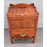 A mid-18th century mahogany tray top commode with a pair of doors over pull out,
