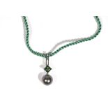 A white gold, green tourmaline, diamond and grey cultured pearl necklace by Autore,
