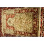 A fine silk keyseri prayer rug, Turkish, the ivory mehrab filled with palmettes,