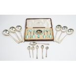 Silver, comprising; six silver and pale blue enamelled teaspoons and a matching tea strainer,