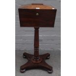 A William IV rosewood teapoy, with four canister interior on turned column and quatrefoil platform,