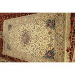 A fine part silk Nain rug, Persian, the ivory field with a central rosette medallion,