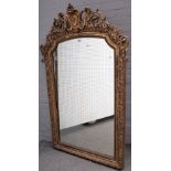 A 19th century French gilt framed arch top mirror, with cartouche crest and floral chased frame,