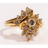 A gold and diamond set cluster ring, in an abstract twist design,