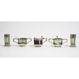 A silver five piece composite condiments set, comprising: a mustard pot, London 1904,