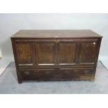 An 18th century and later oak lift top mule chest, with two drawers on block supports,