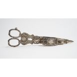 A pair of George III silver scissor action candle snuffers, with scalloped and scrolling decoration,