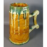 An early 20th century Continental slip decorated lead glazed large tankard, 35cm high.