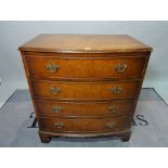 A Regency style walnut bowfront chest, of four long graduated drawers on bracket feet.