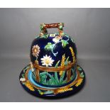 A majolica style blue ground cheese dome and stand, impressed 1189, 29cm. high, (2).