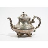 A Victorian silver teapot, of squat tapered circular form, with a scrolling handle,