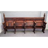 An oak Gothic Revival four seat church pew with pierced trefoil decoration, 236cm wide x 116cm high.