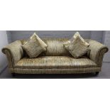 A modern Chesterfield sofa, with patterned yellow striped upholstery on turned ebonised supports,