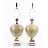 A pair of modern ceramic table lamps of ovoid form, raised on stepped chrome bases, with shades,