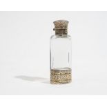 A Victorian silver gilt mounted colourless glass scent bottle cum vinaigrette of oval form,