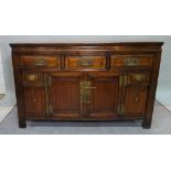 A Chinese stained beech sideboard, with three short drawers, over cupboard base,