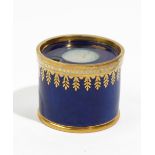 A Sevres blue-ground inkwell, circa 1821, of drum shape with gilt borders,