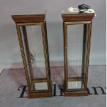 A pair of modern walnut lacquer display cabinets, the mirrored tops on square plinth base,