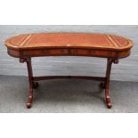 Possibly Brights of Nettlebed, a George III style kidney shaped mahogany two drawer writing table,