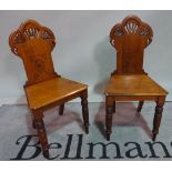 A pair of late Victorian walnut framed hall chairs, 43cm wide x 88cm high.