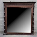 A 19th century oak mirror, with carved fruiting frame and bevelled plate, 137cm wide x 136cm high.