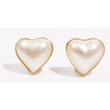 A pair of mabé cultured pearl earclips Of heart shaped design, in a precious yellow metal mounts,