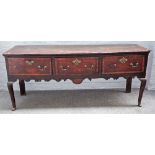 A mid-18th century crossbanded oak three drawer dresser based on turned supports,