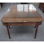 A Regency mahogany 'D' end extending dining table on turned supports, one extra leaf,