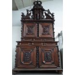 A large early 18th century Italian walnut double height cabinet,