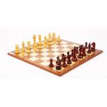A modern boxwood chess set, cased, and hardwood board, both in Mappin and Webb retailers boxes,