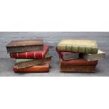 Two 20th century occasional tables, each formed as a stack of leather bound books, both 35cm high,