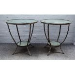 A pair of metal framed mirror inset circular two tier occasional tables,