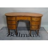 A late Victorian mahogany kidney shaped writing desk,