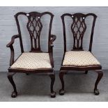 A matched set of twelve George III style mahogany dining chairs on claw and ball feet,