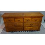 A modern oak side chest, of four short and four long drawers, 160cm wide x 76cm high.