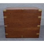 A brass bound campaign style oak rectangular strongbox, with twin locks and side handles,