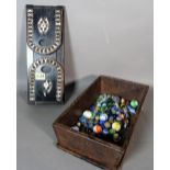 A group of 20th century glass marbles, an ebonised sliding book rack, 34cm,