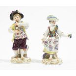 A pair of Meissen figures of vintners, 20th century, a boy playing a recorder,