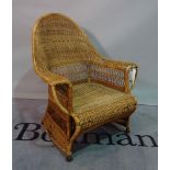 An early 20th century wicker armchair, 73cm wide x 94cm high.